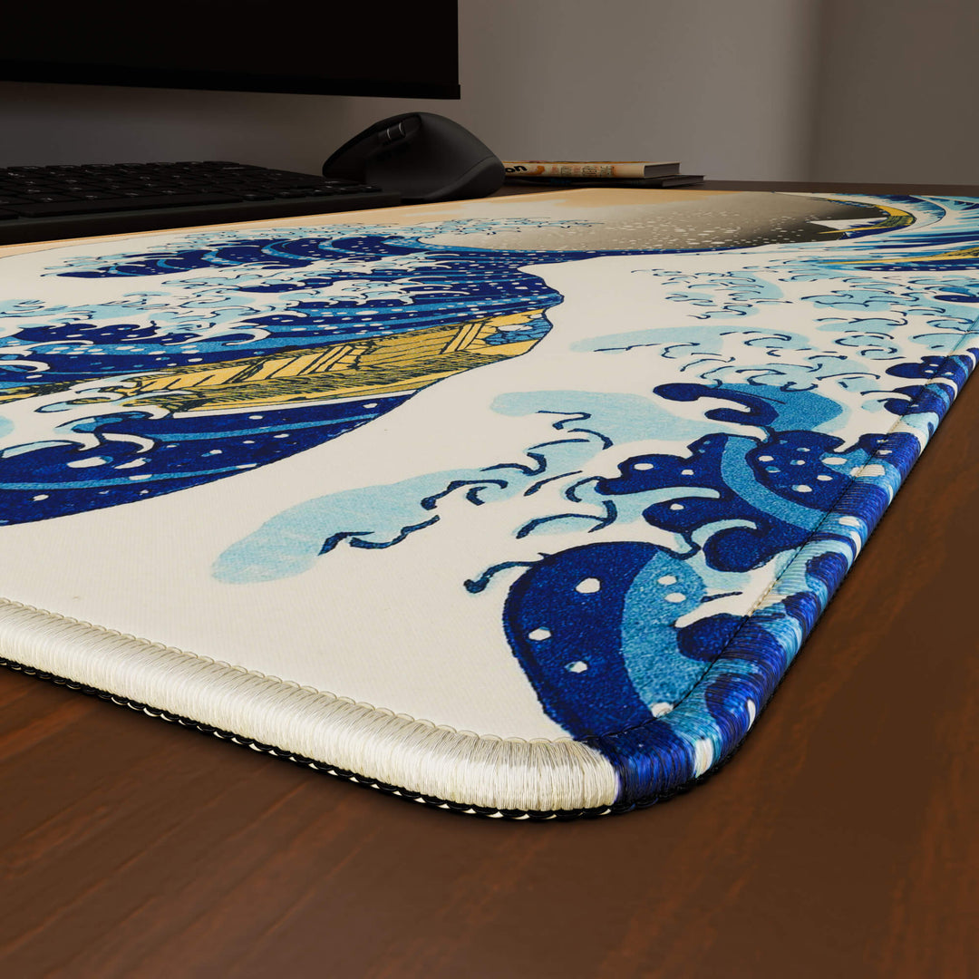 Close-up angled shot highlighting the durable stitched edges of a 90x40CM / 35x15.7in desk mat with the the Great Wave of Kanagawa design. The reinforced stitching prevents fraying, ensuring long-lasting durability and a consistently clean aesthetic.