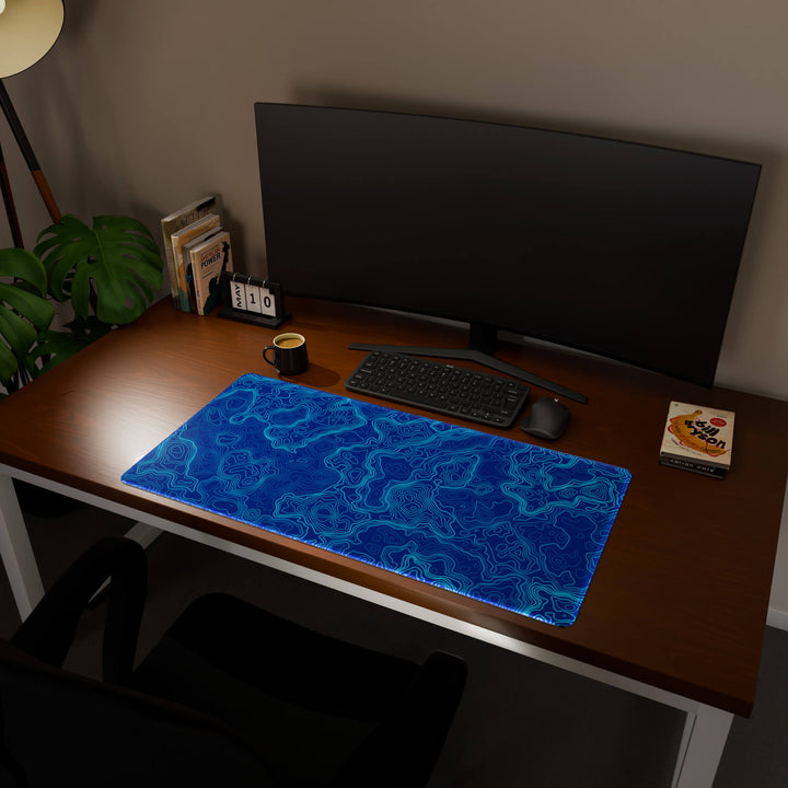 Full desktop view featuring an ultra-wide 100x50CM-39.3x19.6in large mouse pad / desk mat with 'Blue Topographic' design, inspired by blue minimalist topographic art. Offering excellent desk protection and space, this oversized mat is ideal for multi-monitor setups or users requiring vast movement freedom.