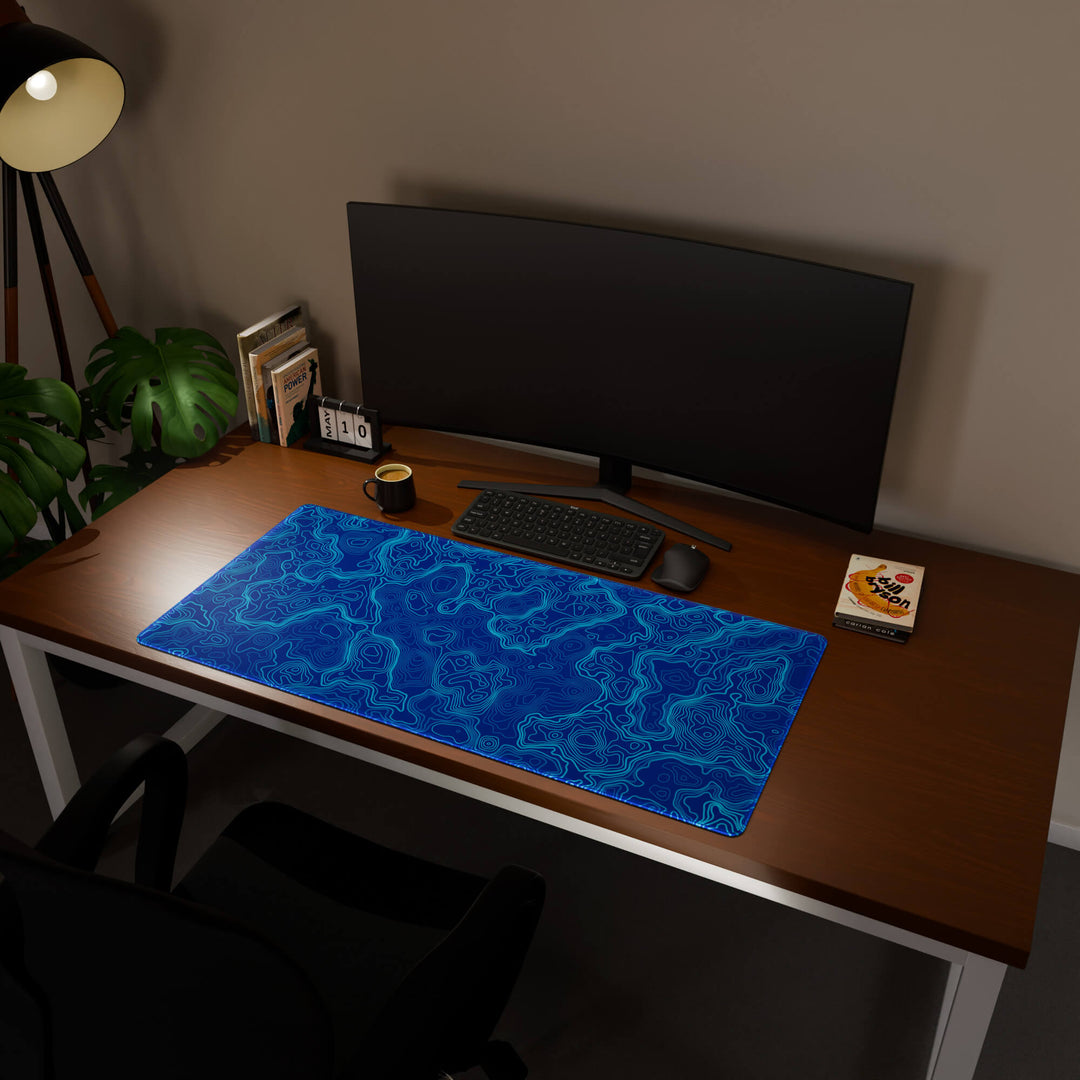 Full desktop view featuring a generously sized 120x57CM-47x22.4in large mouse pad / desk mat with 'Blue Topographic' design, inspired by blue minimalist topographic art. Its ample dimensions cater to both demanding gaming and professional tasks, ensuring consistent performance and a neat workspace.
