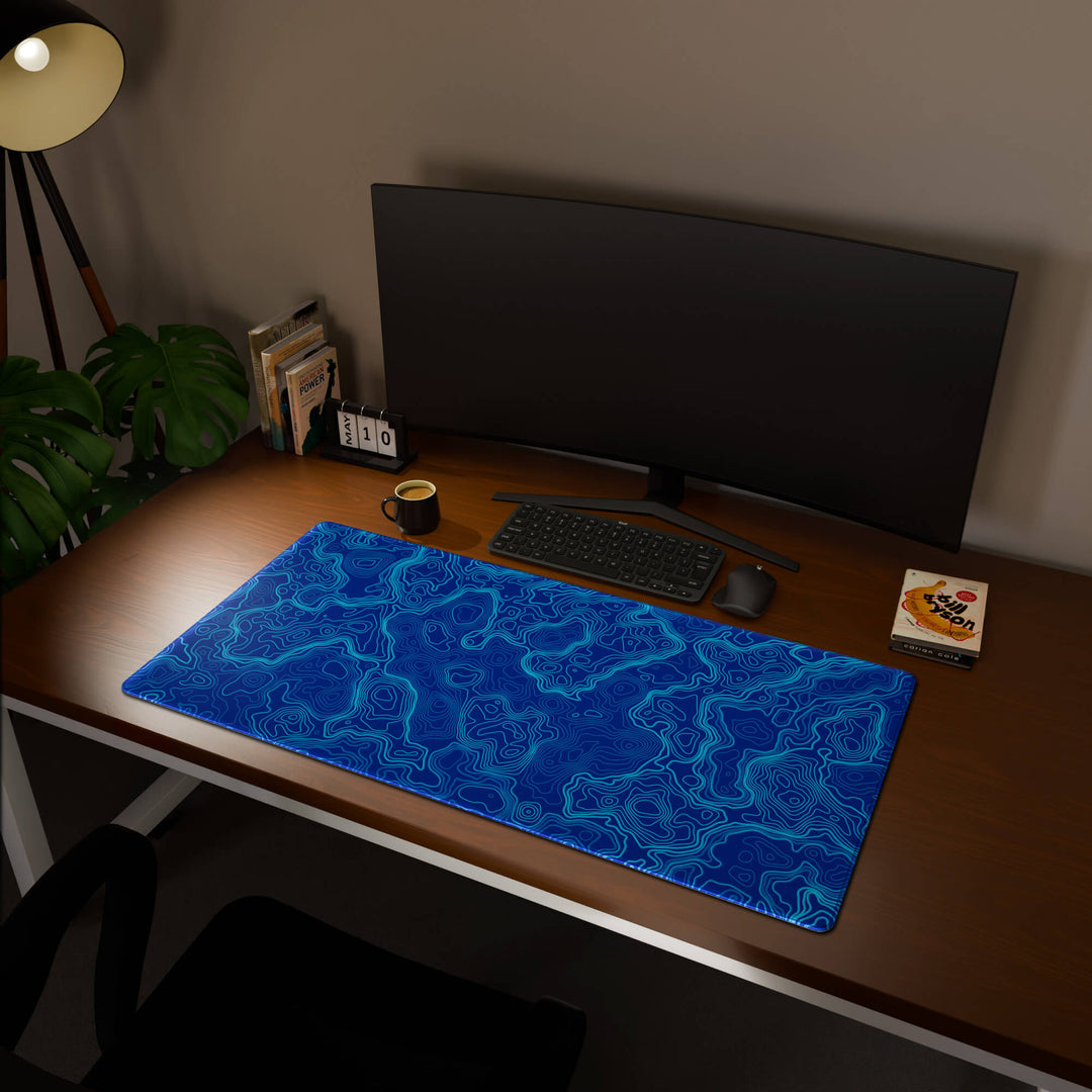Full desktop view featuring an extra-large 120x60CM-47x23.6in large mouse pad / desk mat with 'Blue Topographic' design, inspired by blue minimalist topographic art. This maximum coverage mat transforms your entire desk surface into a unified, high-performance area, perfect for demanding users and full-desk setups.