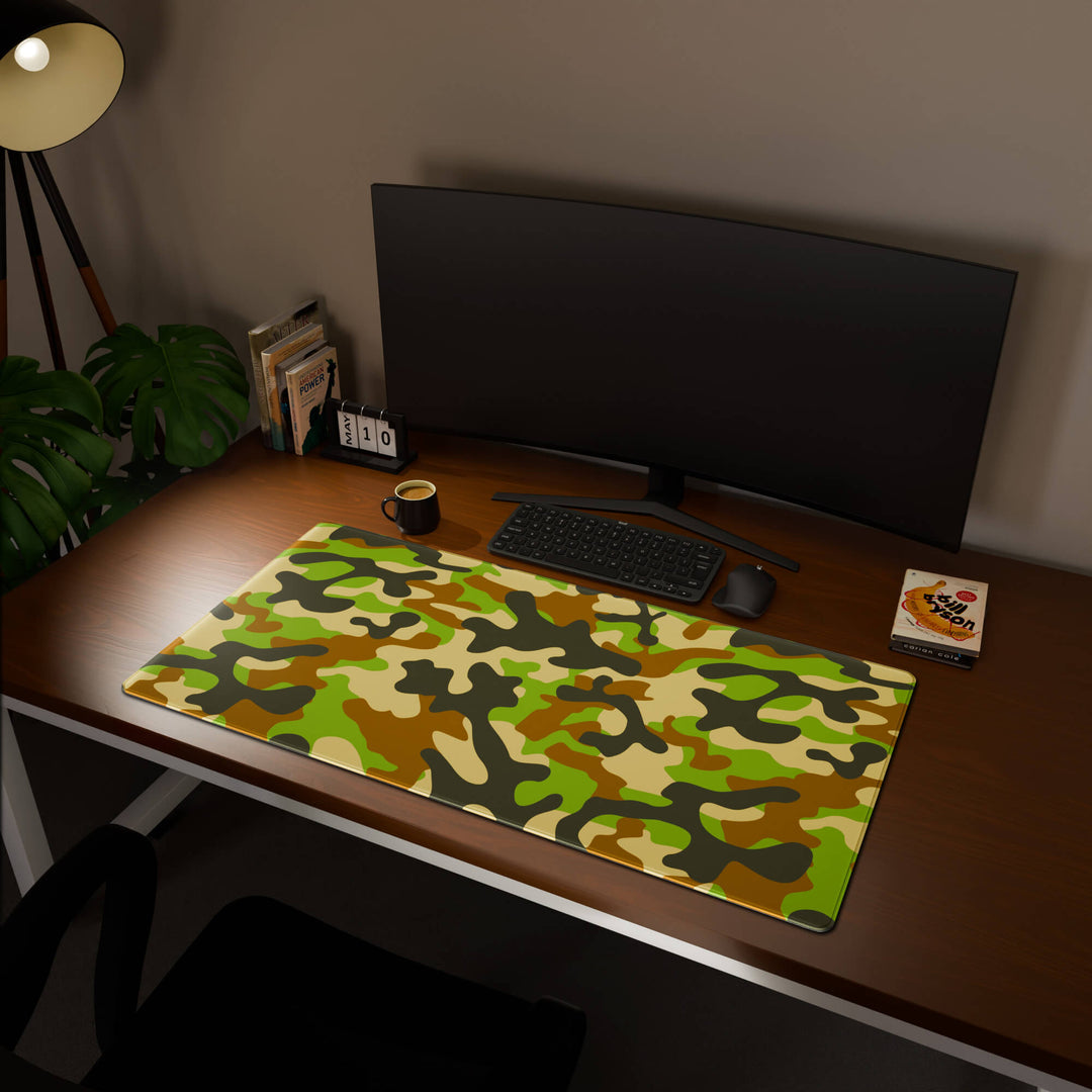 Full desktop view featuring an extra-large 120x60CM-47x23.6in large mouse pad / desk mat with 'Woodland Camo' design, inspired by a classic woodland camouflage pattern. This maximum coverage mat transforms your entire desk surface into a unified, high-performance area, perfect for demanding users and full-desk setups.