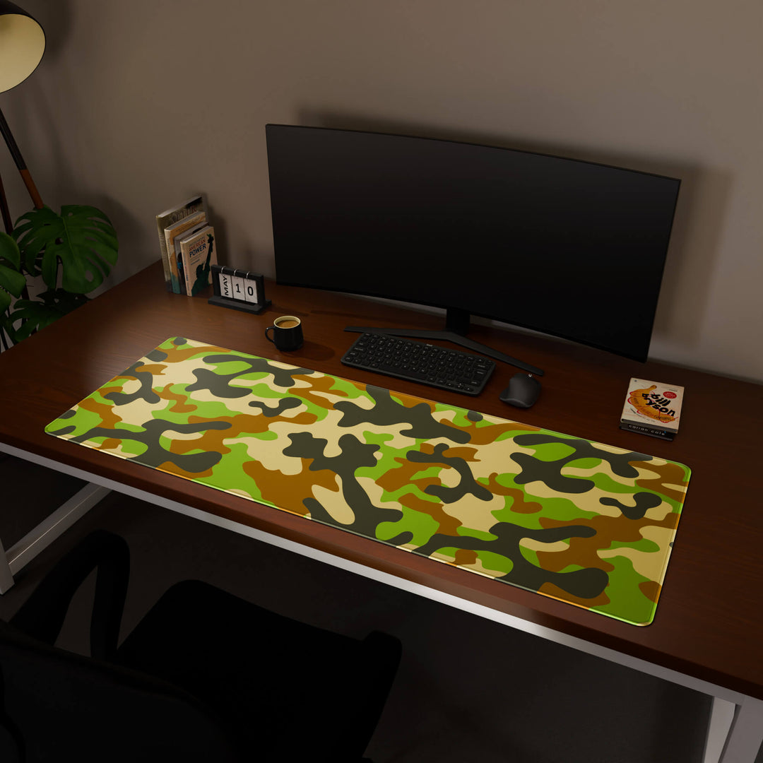 Full desktop view featuring a massive 160x57CM-63x22.4in large mouse pad / desk mat with 'Woodland Camo' design, inspired by a classic woodland camouflage pattern. This premium, full-desk mat provides the ultimate coverage for an entire workstation, protecting the surface and unifying the space.