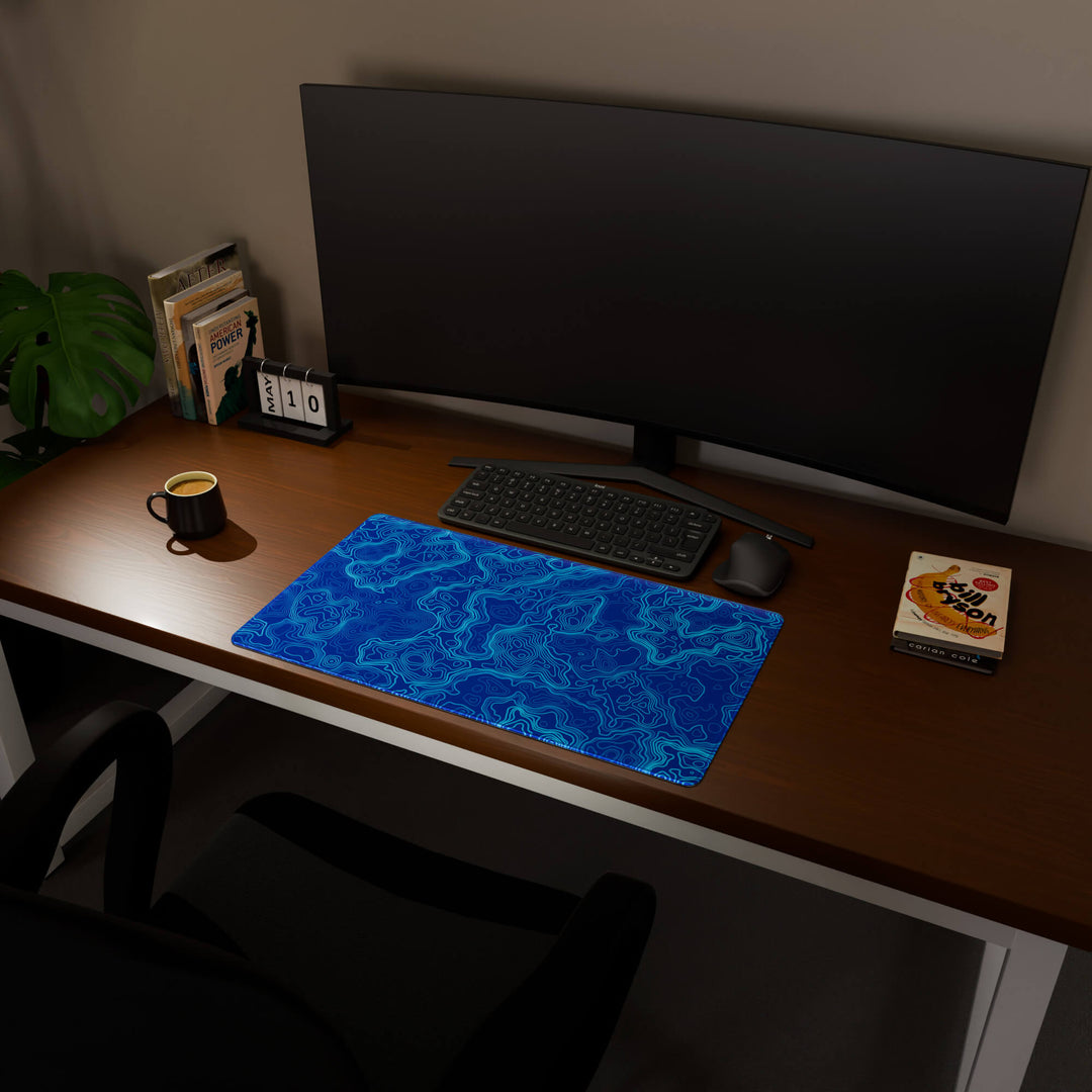 Full desktop view featuring a deep 70x40CM-27.5x15.7in large mouse pad / desk mat with 'Blue Topographic' design, inspired by blue minimalist topographic art. The increased depth offers more wrist and arm support, enhancing comfort during prolonged computer use and protecting the desk below.