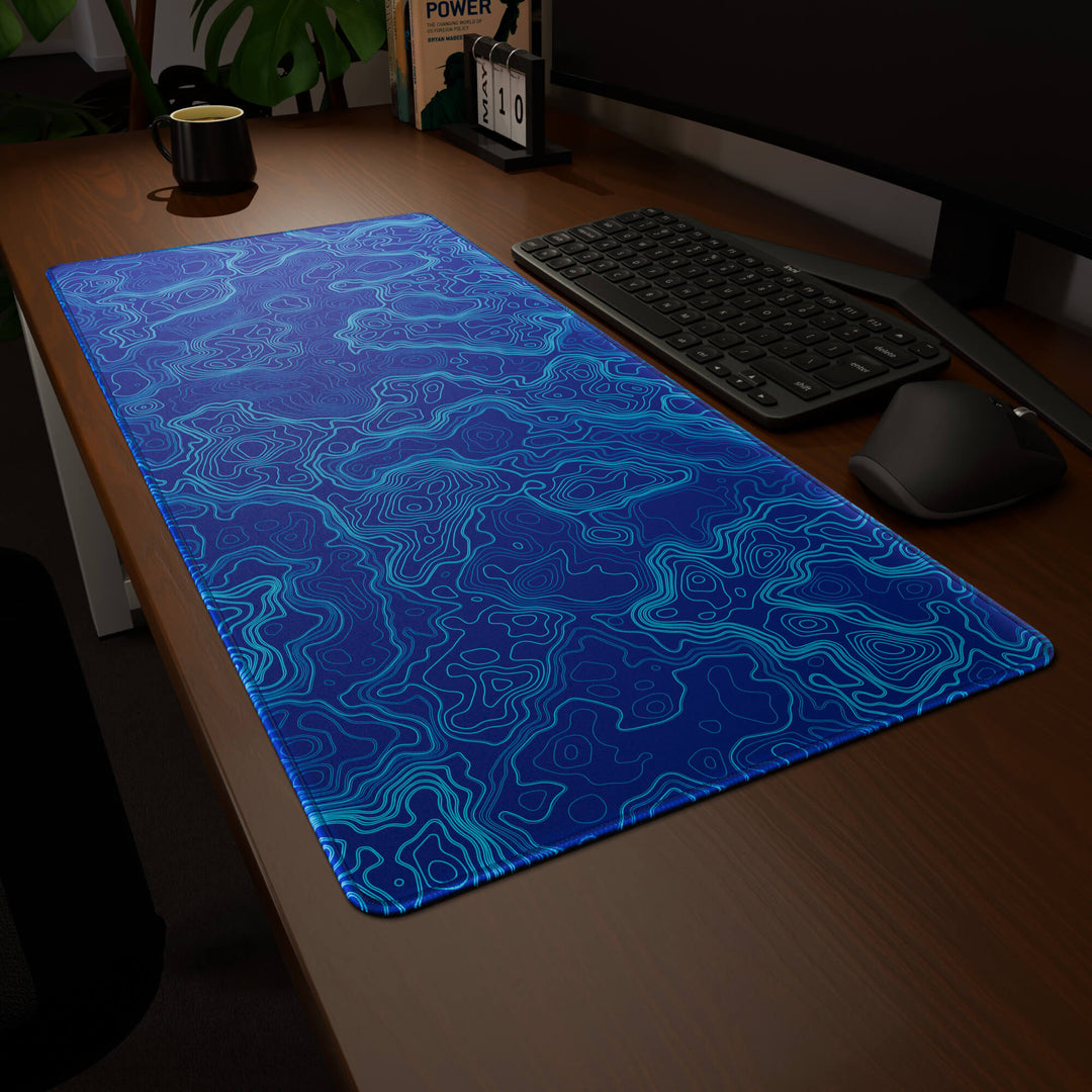 Clean angled presentation of a 90x40CM / 35x15.7in large mouse pad / desk mat showcasing the dramatic 'Blue Topographic' design, inspired by blue minimalist topographic art. Its high-quality fabric surface is designed for optical and laser mice, delivering superior tracking performance and responsiveness.