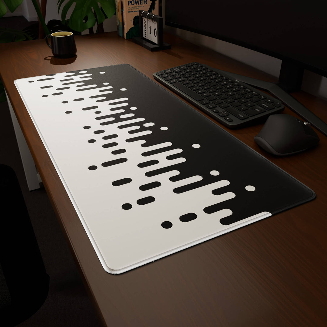 Clean angled presentation of a 90x40CM / 35x15.7in large mouse pad / desk mat showcasing the dramatic 'Monochrome Drip' design, inspired by black and white minimalist art. Its high-quality fabric surface is designed for optical and laser mice, delivering superior tracking performance and responsiveness.