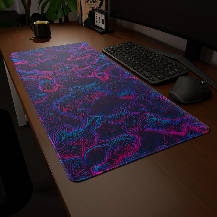 Clean angled presentation of a 90x40CM / 35x15.7in large mouse pad / desk mat showcasing the dramatic 'Vaporwave Topographic' design, inspired by vibrant vaporwave and neon topographic art. Its high-quality fabric surface is designed for optical and laser mice, delivering superior tracking performance and responsiveness.
