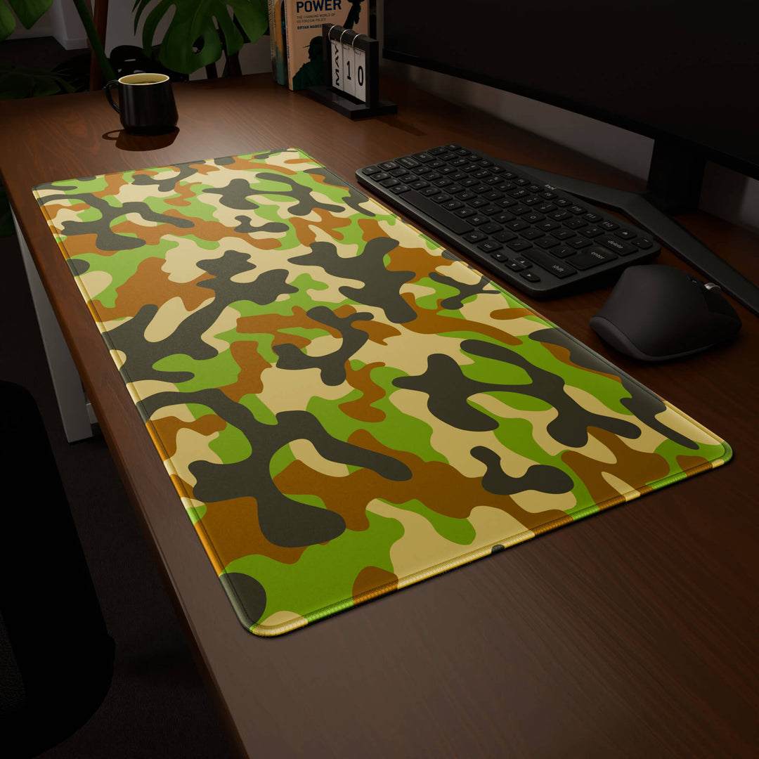 Clean angled presentation of a 90x40CM / 35x15.7in large mouse pad / desk mat showcasing the dramatic 'Woodland Camo' design, inspired by a classic woodland camouflage pattern. Its high-quality fabric surface is designed for optical and laser mice, delivering superior tracking performance and responsiveness.