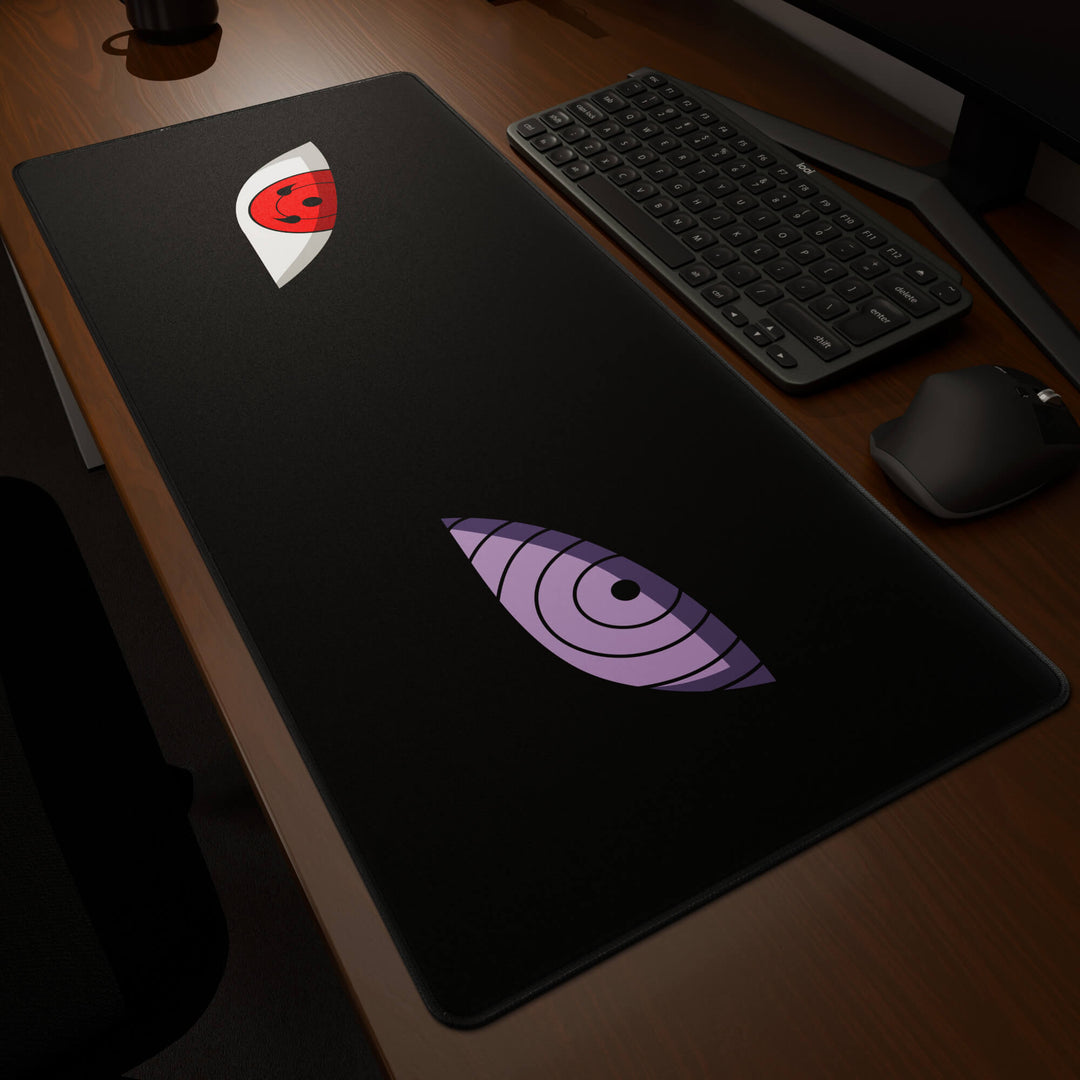 Dynamic angled perspective of a 90x40CM / 35x15.7in large mouse pad / desk mat featuring the vivid 'Dōjutsu' design, inspired by minimalist anime ninja eyes. Its generous dimensions offer a vast, smooth area that protects your desk while enhancing mouse glide and overall comfort.