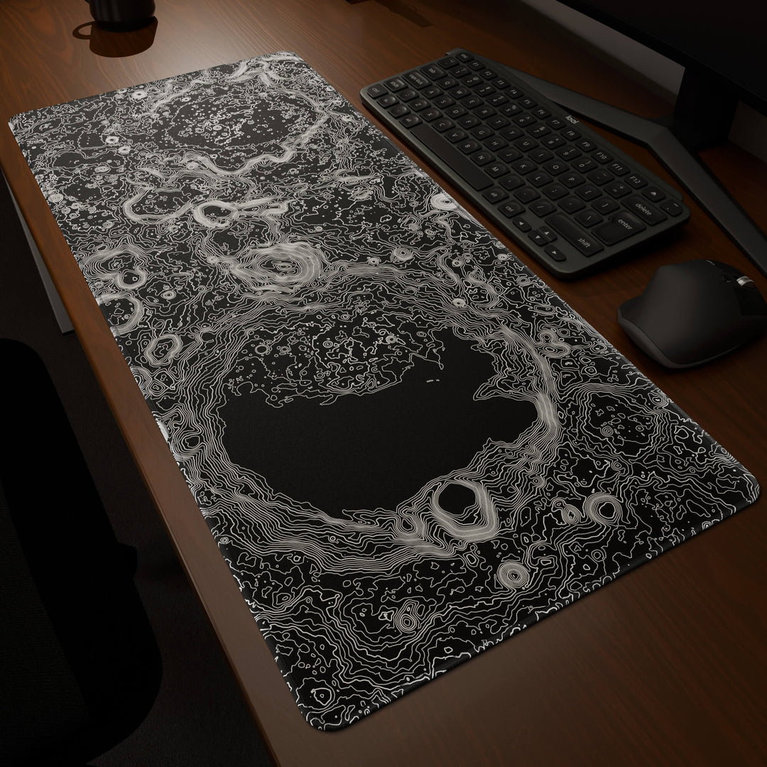 Dynamic angled perspective of a 90x40CM / 35x15.7in large mouse pad / desk mat featuring the vivid 'Lunar Topographic' design, inspired by minimalist lunar surface art. Its generous dimensions offer a vast, smooth area that protects your desk while enhancing mouse glide and overall comfort.