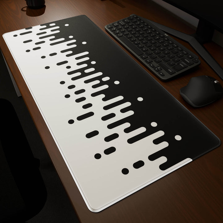 Dynamic angled perspective of a 90x40CM / 35x15.7in large mouse pad / desk mat featuring the vivid 'Monochrome Drip' design, inspired by black and white minimalist art. Its generous dimensions offer a vast, smooth area that protects your desk while enhancing mouse glide and overall comfort.