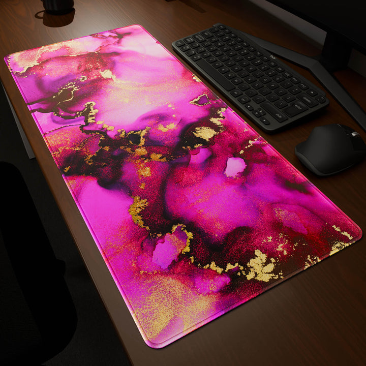 Dynamic angled perspective of a 90x40CM / 35x15.7in large mouse pad / desk mat featuring the vivid 'Pink & Gold' design, inspired by pink and gold alcohol ink art. Its generous dimensions offer a vast, smooth area that protects your desk while enhancing mouse glide and overall comfort.