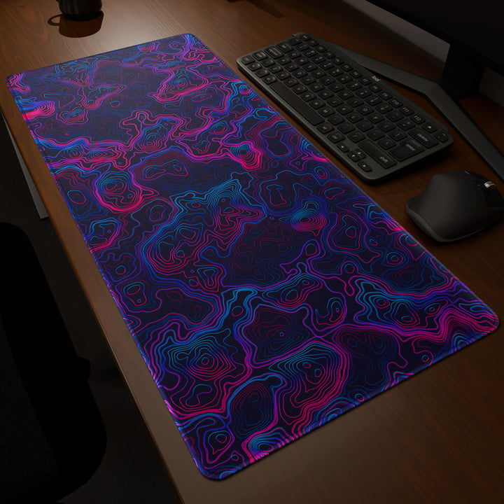 Dynamic angled perspective of a 90x40CM / 35x15.7in large mouse pad / desk mat featuring the vivid 'Vaporwave Topographic' design, inspired by vibrant vaporwave and neon topographic art. Its generous dimensions offer a vast, smooth area that protects your desk while enhancing mouse glide and overall comfort.