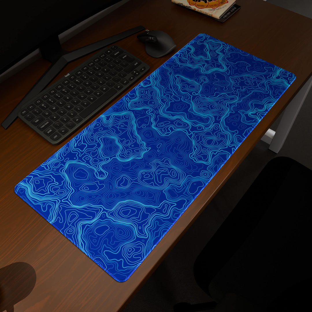 Elevated view of a 90x40CM / 35x15.7in large mouse pad / desk mat prominently displaying the 'Blue Topographic' design, inspired by blue minimalist topographic art. This premium mat provides a stable, non-slip surface, crucial for maintaining focus and accuracy during intense gaming or work sessions.