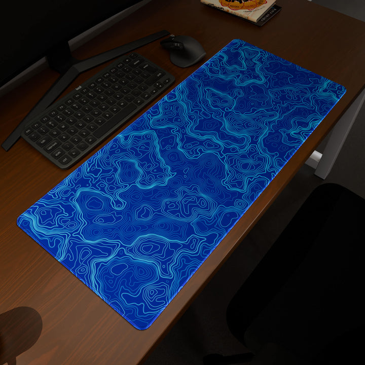 Elevated view of a 90x40CM / 35x15.7in large mouse pad / desk mat prominently displaying the 'Blue Topographic' design, inspired by blue minimalist topographic art. This premium mat provides a stable, non-slip surface, crucial for maintaining focus and accuracy during intense gaming or work sessions.