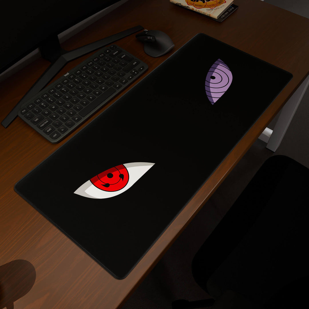 Elevated view of a 90x40CM / 35x15.7in large mouse pad / desk mat prominently displaying the 'Dōjutsu' design, inspired by minimalist anime ninja eyes. This premium mat provides a stable, non-slip surface, crucial for maintaining focus and accuracy during intense gaming or work sessions.