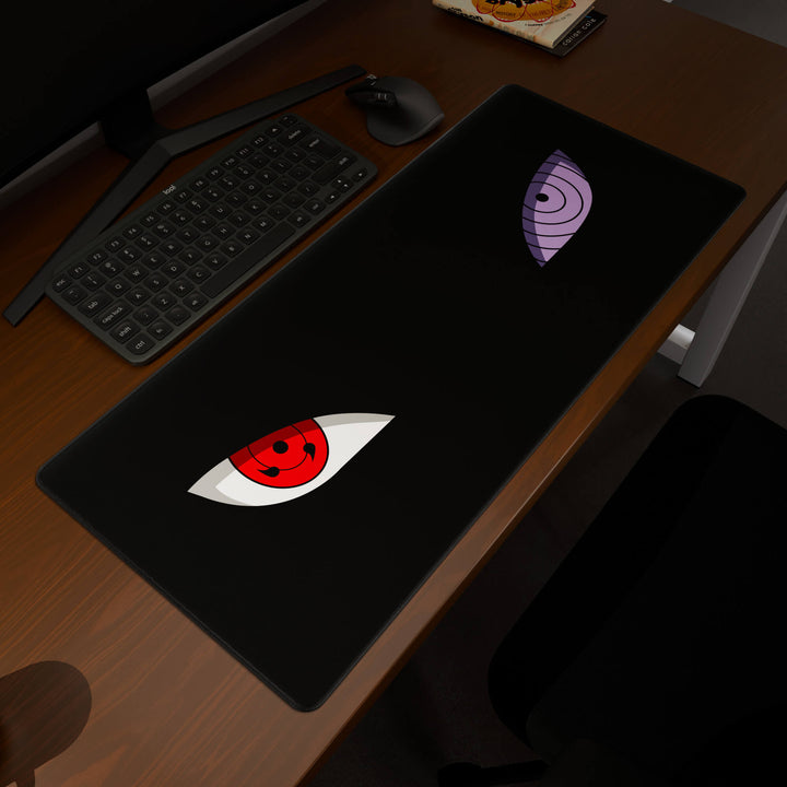 Elevated view of a 90x40CM / 35x15.7in large mouse pad / desk mat prominently displaying the 'Dōjutsu' design, inspired by minimalist anime ninja eyes. This premium mat provides a stable, non-slip surface, crucial for maintaining focus and accuracy during intense gaming or work sessions.