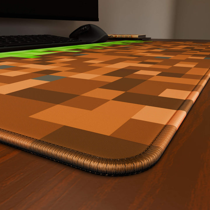 Close-up angled shot highlighting the durable stitched edges of a 90x40CM / 35x15.7in large mouse pad / desk mat with the 'Blocks' design. The reinforced stitching prevents fraying, ensuring long-lasting durability and a consistently clean aesthetic.
