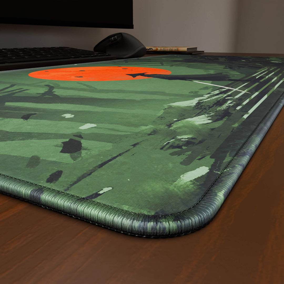 Close-up angled shot highlighting the durable stitched edges of a 90x40CM / 35x15.7in large mouse pad / desk mat with the 'Blood Moon Samurai' design, inspired by dark fantasy samurai art. The reinforced stitching prevents fraying, ensuring long-lasting durability and a consistently clean aesthetic.