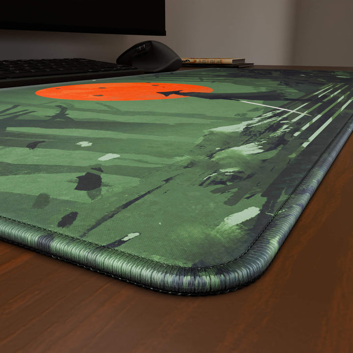 Close-up angled shot highlighting the durable stitched edges of a 90x40CM / 35x15.7in large mouse pad / desk mat with the 'Blood Moon Samurai' design, inspired by dark fantasy samurai art. The reinforced stitching prevents fraying, ensuring long-lasting durability and a consistently clean aesthetic.