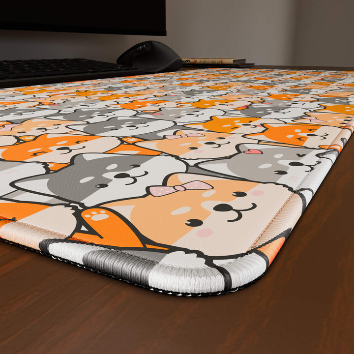 Close-up angled shot highlighting the durable stitched edges of a 90x40CM / 35x15.7in large mouse pad / desk mat with the 'Miniature Pups' design, inspired by a cute kawaii dog pattern. The reinforced stitching prevents fraying, ensuring long-lasting durability and a consistently clean aesthetic.