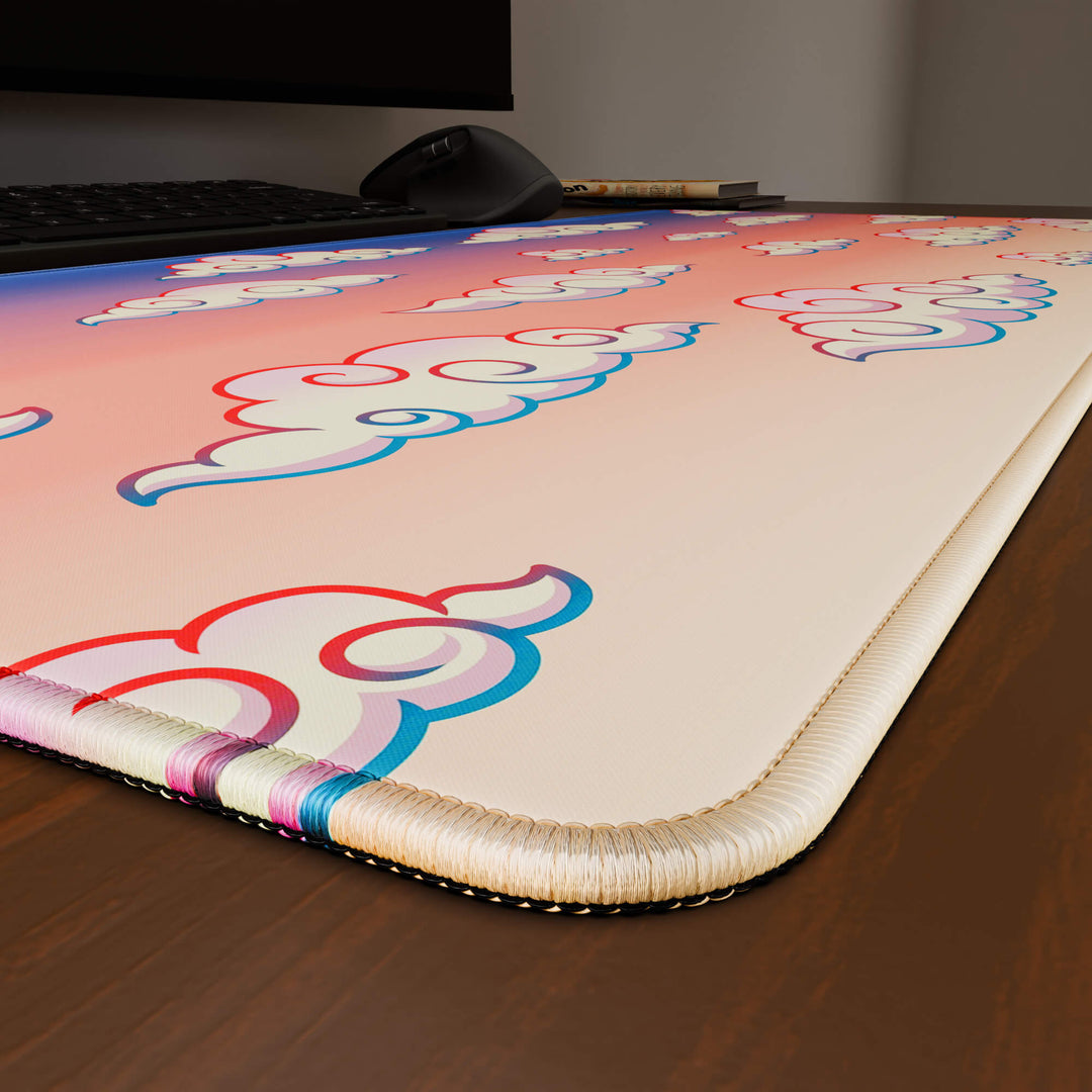 Close-up angled shot highlighting the durable stitched edges of a 90x40CM / 35x15.7in large mouse pad / desk mat with the 'Sunset Clouds' design, inspired by Naruto and vibrant Japanese anime art. The reinforced stitching prevents fraying, ensuring long-lasting durability and a consistently clean aesthetic.