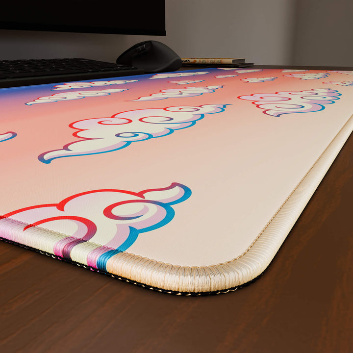 Close-up angled shot highlighting the durable stitched edges of a 90x40CM / 35x15.7in large mouse pad / desk mat with the 'Sunset Clouds' design, inspired by Naruto and vibrant Japanese anime art. The reinforced stitching prevents fraying, ensuring long-lasting durability and a consistently clean aesthetic.