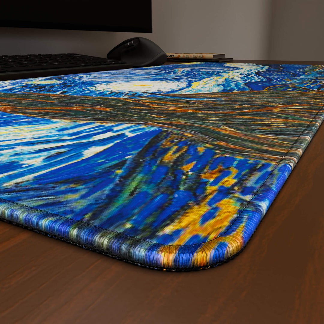 Close-up angled shot highlighting the durable stitched edges of a 90x40CM / 35x15.7in large mouse pad / desk mat with 'The Starry Night' design, inspired by Van Gogh classic art. The reinforced stitching prevents fraying, ensuring long-lasting durability and a consistently clean aesthetic.