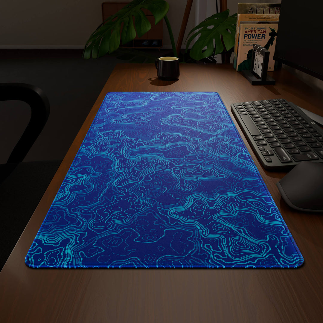 Wide angled view of a complete desk setup, featuring a 90x40CM / 35x15.7in large mouse pad / desk mat with the captivating 'Blue Topographic' design, inspired by blue minimalist topographic art. This extra-large mousepad seamlessly integrates into any workspace, providing a cohesive and productive environment.