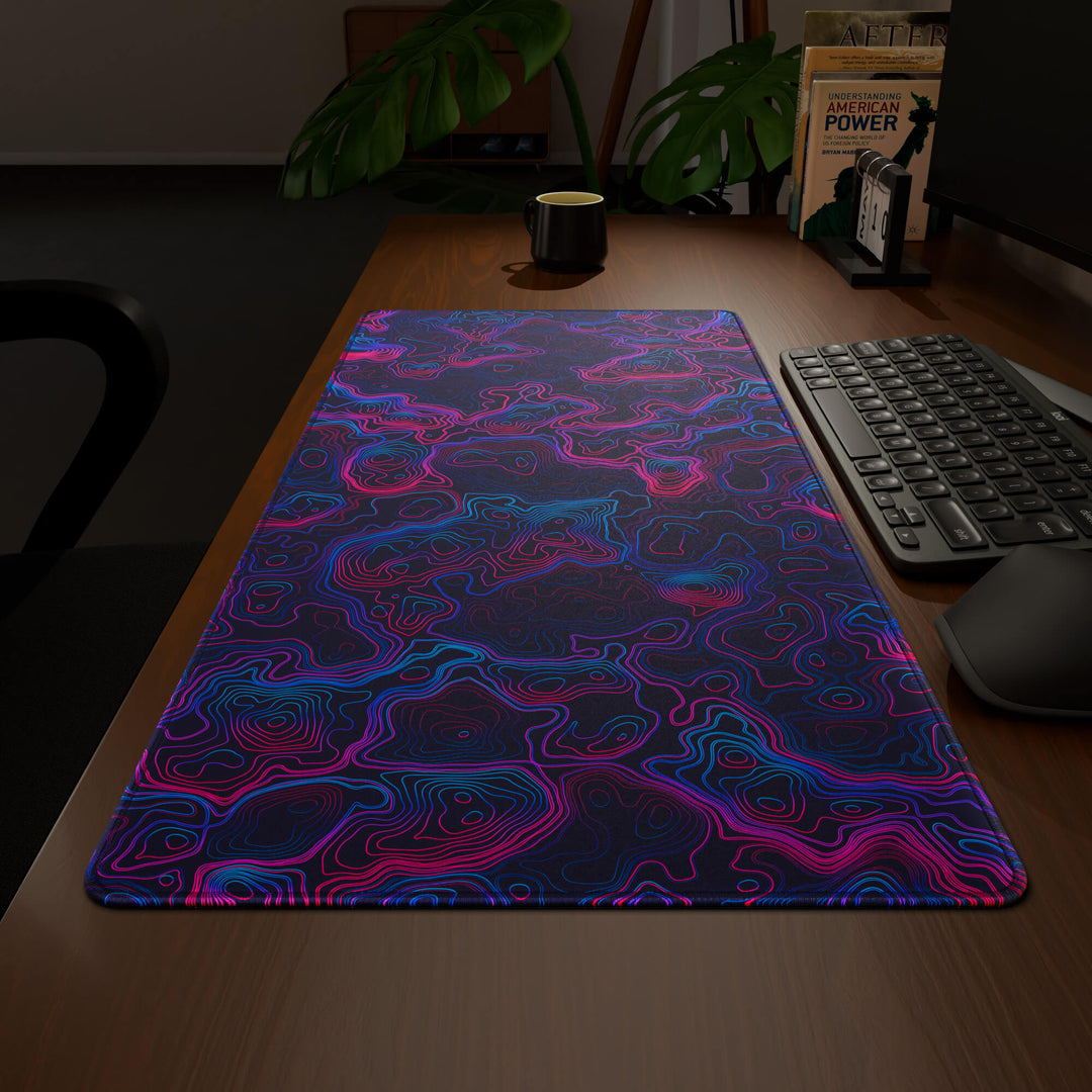 Wide angled view of a complete desk setup, featuring a 90x40CM / 35x15.7in large mouse pad / desk mat with the captivating 'Vaporwave Topographic' design, inspired by vibrant vaporwave and neon topographic art. This extra-large mousepad seamlessly integrates into any workspace, providing a cohesive and productive environment.